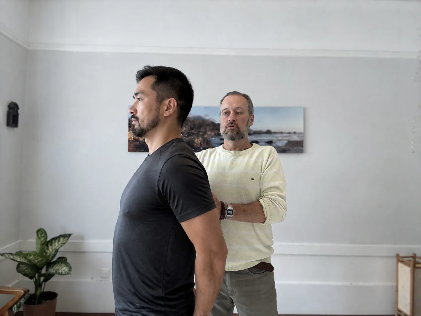 Garrett guiding a standing client’s shoulder position
